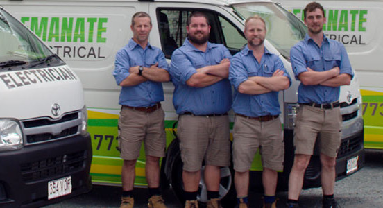 Emanate Electrical Services team standing near their services vans