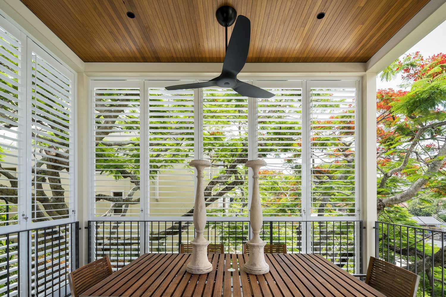 Black Big Ass Haiku fan Installed between two black titanium dusk downlights